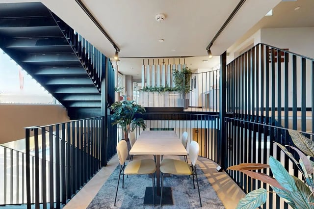 Table with chairs and plants communal area at Bridgeside in Nottingham Student Accommodation