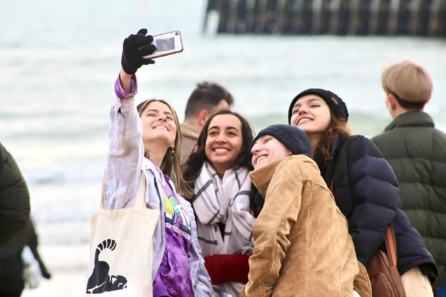 Friends taking selfie on beach exterior at Bournemouth University Village - Chesil House in Bournemouth Student Accommodation
