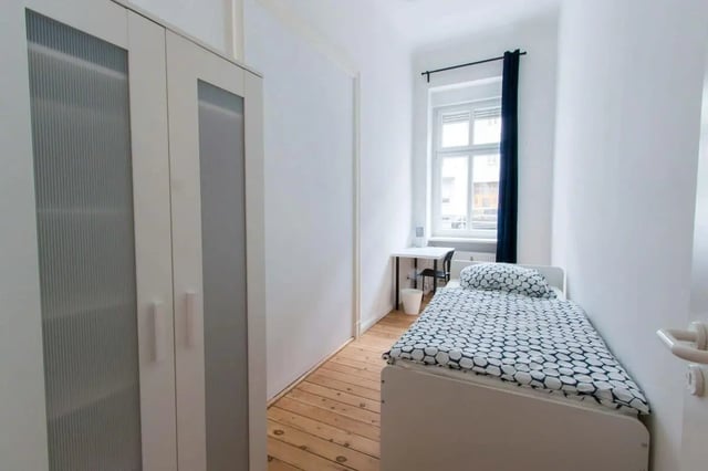 White wardrobe bed desk with chair and window Bedroom at Detmolder Straße 21.3 in Berlin Student Accommodation