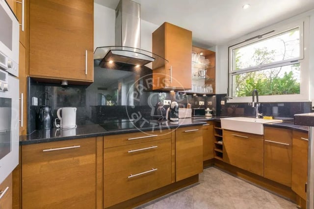 Wooden cabinets sink window and appliances kitchen at Apartment in Quai Louis Blériot, 75016 Paris, France in Paris Student Accommodation