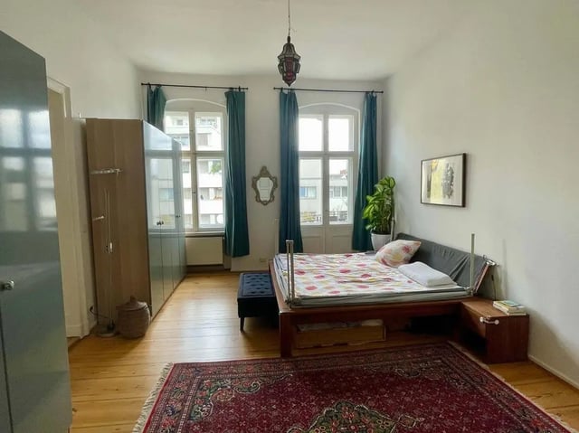 Bed wardrobe windows rug and ornate lamp bedroom at Apartment in Wallstraße, Berlin for 100 m² in Berlin Student Accommodation