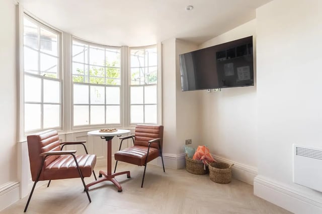 Two leather chairs table and television living room at Hamilton House in Brighton Student Accommodation
