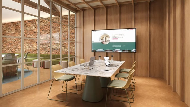 Marble conference table with laptops and chairs meeting area at Hamilton House in Brighton Student Accommodation