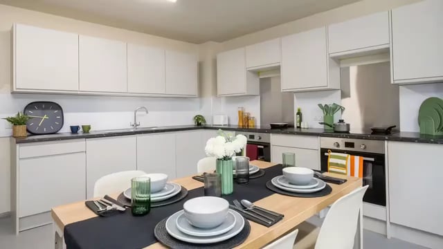 Dining table with place settings and modern kitchen at Hardwick Campus in Cheltenham Student Accommodation