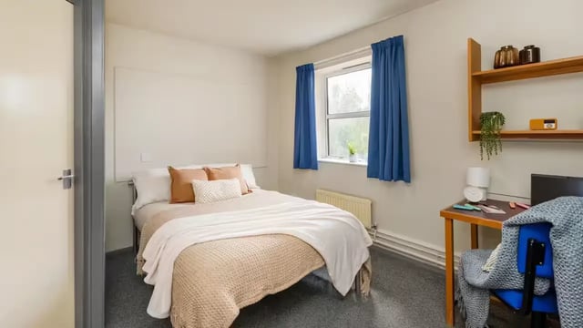 Bed desk and shelves student bedroom interior. at Hardwick Campus in Cheltenham Student Accommodation