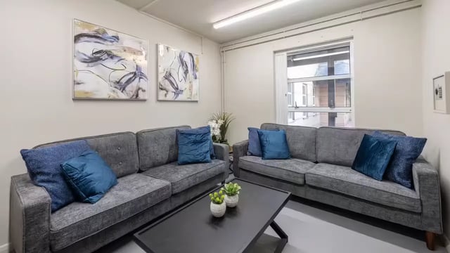 Two grey sofas with blue cushions living room at Hardwick Campus in Cheltenham Student Accommodation