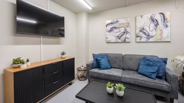 Sofa coffee table artwork and television living room at Hardwick Campus in Cheltenham Student Accommodation