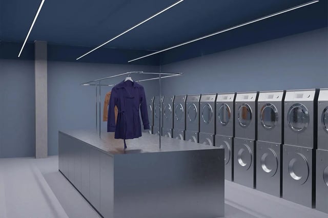 Row of washing machines and a silver counter laundry room at Studeo by UniLodge in Melbourne Student Accommodation