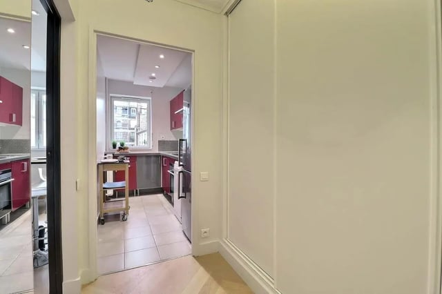Red cabinets stainless steel appliances cart kitchen at Apartment in Pass. du Guesclin, 75015 Paris, France in Paris Student Accommodation