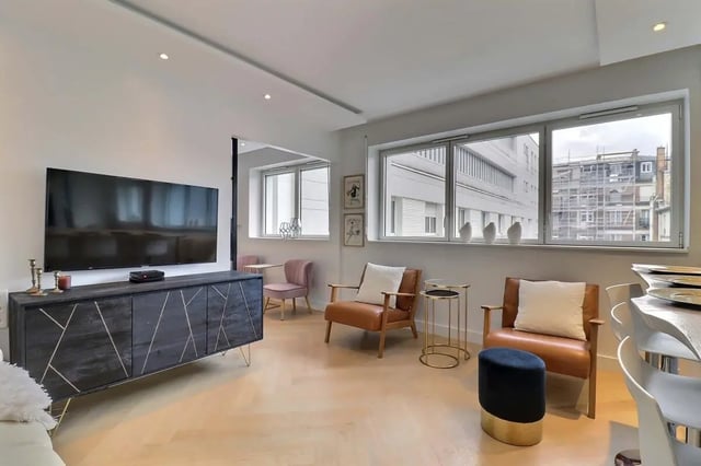 Modern living room with TV, chairs, table, window living room at Apartment in Pass. du Guesclin, 75015 Paris, France in Paris Student Accommodation
