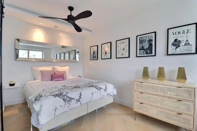 Bed with pink pillows dresser and framed prints bedroom at Apartment in Pass. du Guesclin, 75015 Paris, France in Paris Student Accommodation