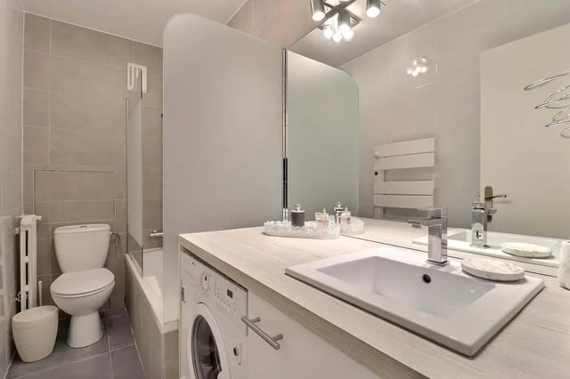 Toilet sink washing machine and bathtub bathroom at Apartment in Pass. du Guesclin, 75015 Paris, France in Paris Student Accommodation