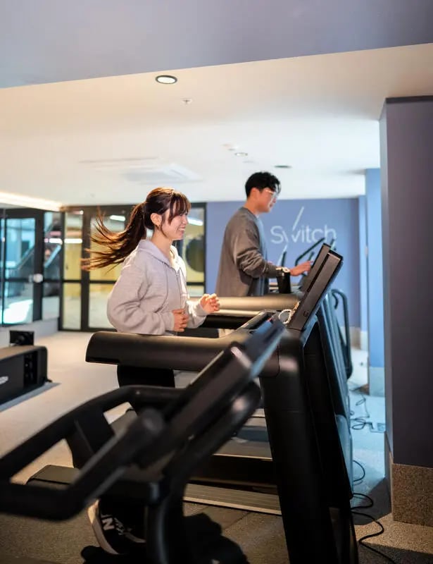 Treadmills with people exercising gym at The Switch Lachlan Macquarie Park in Sydney Student Accommodation