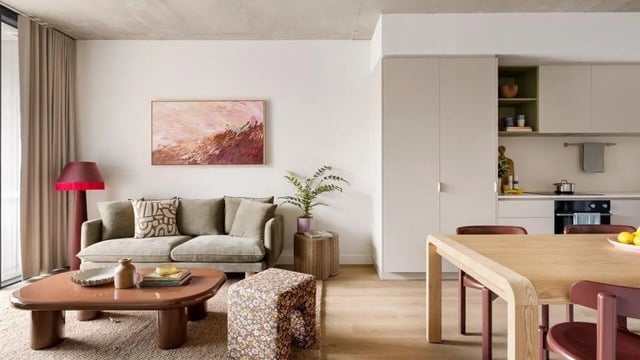 Sofa coffee table lamp and kitchen area living room at Assemble Swiftwalk in Melbourne Student Accommodation