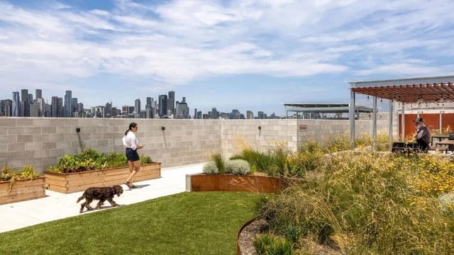 Rooftop garden with seating and skyline view exterior at Assemble Swiftwalk in Melbourne Student Accommodation