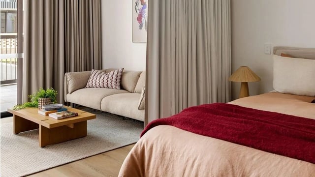 Sofa and coffee table visible living room bedroom at Assemble Swiftwalk in Melbourne Student Accommodation