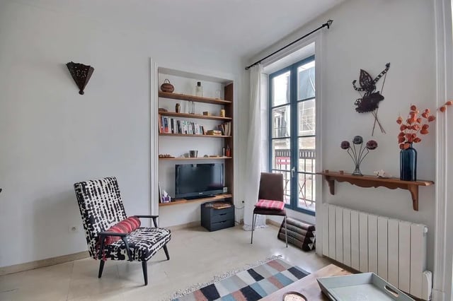 Armchairs bookshelf TV and window Living room at Apartment in Rue Bergère, 75009 Paris, France in Paris Student Accommodation