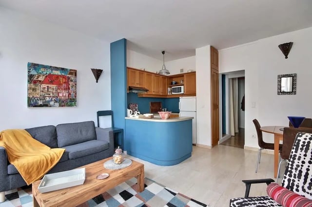 Sofa coffee table kitchen area rug living room at Apartment in Rue Bergère, 75009 Paris, France in Paris Student Accommodation