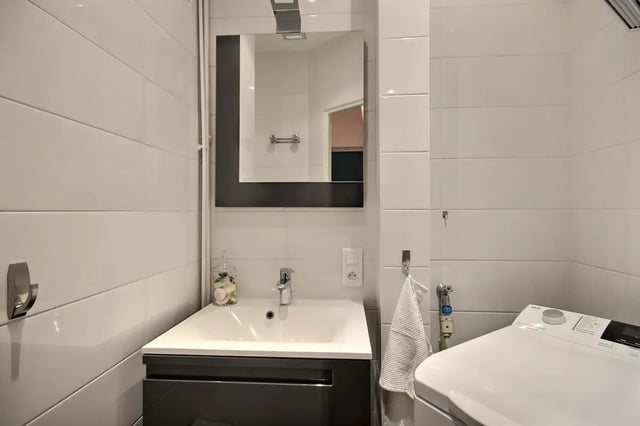 Sink mirror towel washing machine bathroom at Apartment in Rue Bergère, 75009 Paris, France in Paris Student Accommodation