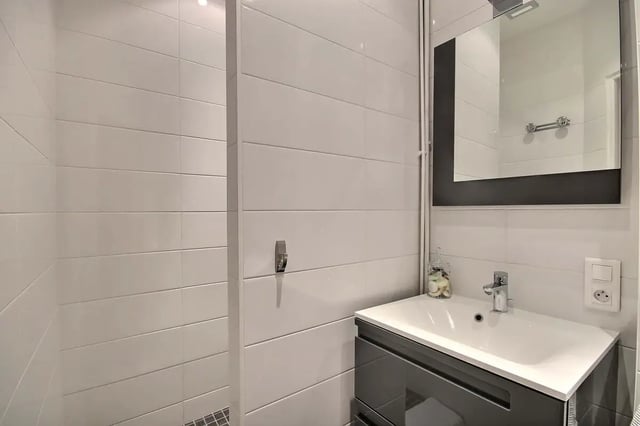 Modern bathroom vanity sink and tiled shower enclosure at Apartment in Rue Bergère, 75009 Paris, France in Paris Student Accommodation