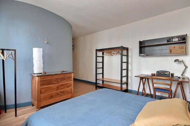 Bed dresser shelf desk lamp bedroom at Apartment in Rue Bergère, 75009 Paris, France in Paris Student Accommodation