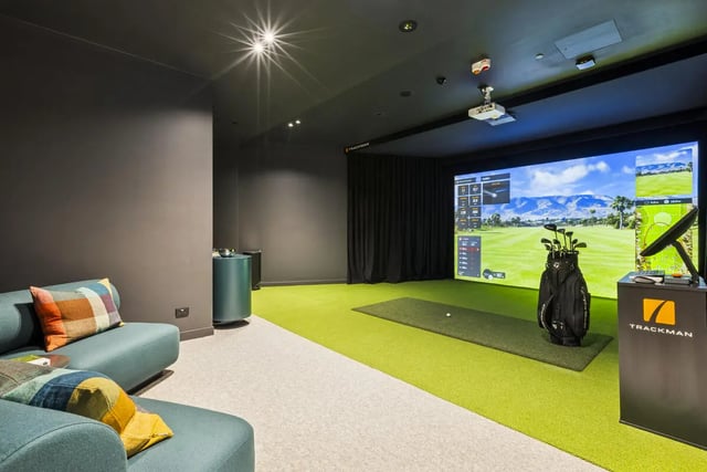 Golf simulator with couch and golf bag playing area at West Tower, Melbourne Quarter in Melbourne Student Accommodation