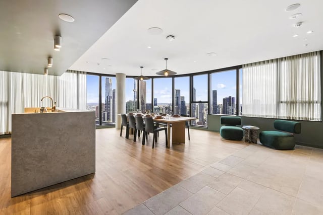 Kitchen island dining table and green chairs communal area at West Tower, Melbourne Quarter in Melbourne Student Accommodation