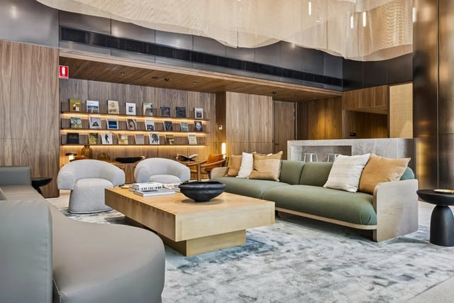 Sofa chairs coffee table bookshelves common area living room at West Tower, Melbourne Quarter in Melbourne Student Accommodation