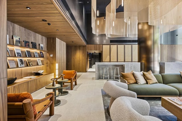 Sofa chairs bookshelves and bar area lounge at West Tower, Melbourne Quarter in Melbourne Student Accommodation
