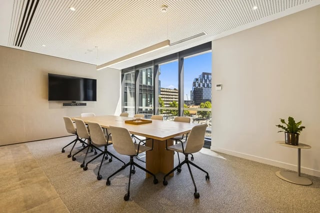 Table chairs television large window meeting room at West Tower, Melbourne Quarter in Melbourne Student Accommodation
