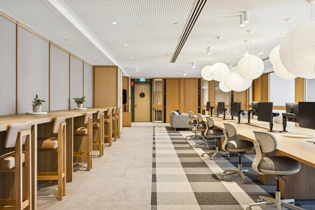 Wooden counter with stools and computer workstations study area at West Tower, Melbourne Quarter in Melbourne Student Accommodation