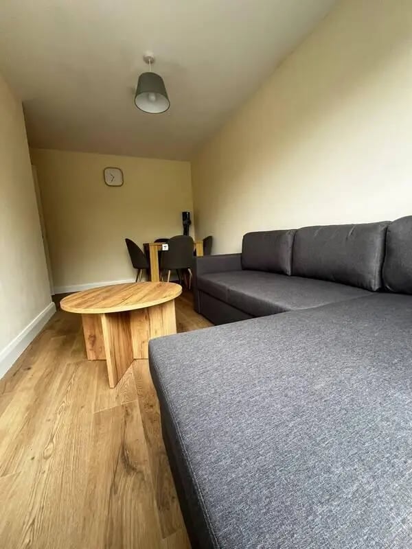 Grey sectional sofa wooden coffee table dining set living room at 16 Emmet Lodge, Emmet Court, Dublin 8 D08 EY83 in Dublin Student Accommodation