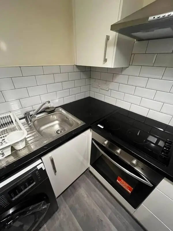 Sink dishwasher oven with white tiles kitchen at 16 Emmet Lodge, Emmet Court, Dublin 8 D08 EY83 in Dublin Student Accommodation