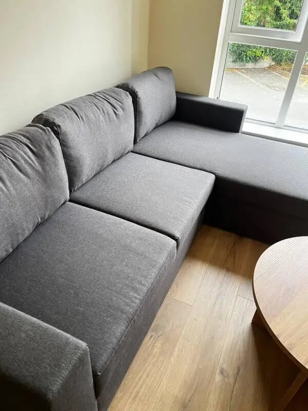 Gray sectional sofa and round coffee table living room at 16 Emmet Lodge, Emmet Court, Dublin 8 D08 EY83 in Dublin Student Accommodation