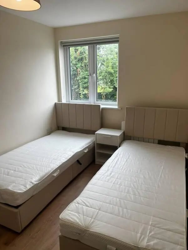 Two beds bedside table window bedroom at 16 Emmet Lodge, Emmet Court, Dublin 8 D08 EY83 in Dublin Student Accommodation