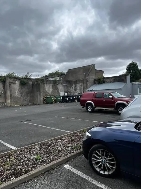 Cars and dumpsters in a parking lot exterior at 16 Emmet Lodge, Emmet Court, Dublin 8 D08 EY83 in Dublin Student Accommodation