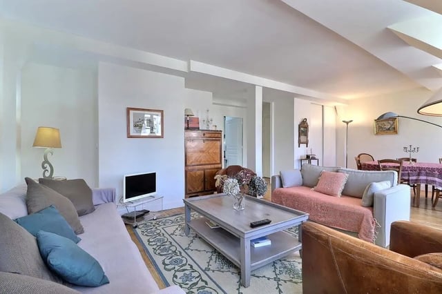 Sofas coffee table television rug and dining area living room at Apartment in Rue César Franck, 75015 Paris, France in Paris Student Accommodation