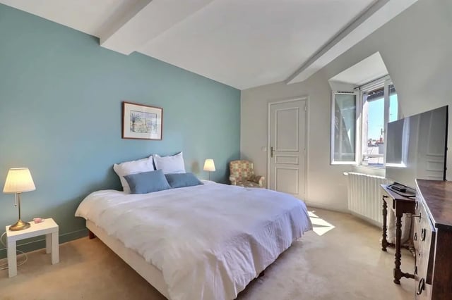 Bed side tables painting lamp and bed bedroom at Apartment in Rue César Franck, 75015 Paris, France in Paris Student Accommodation