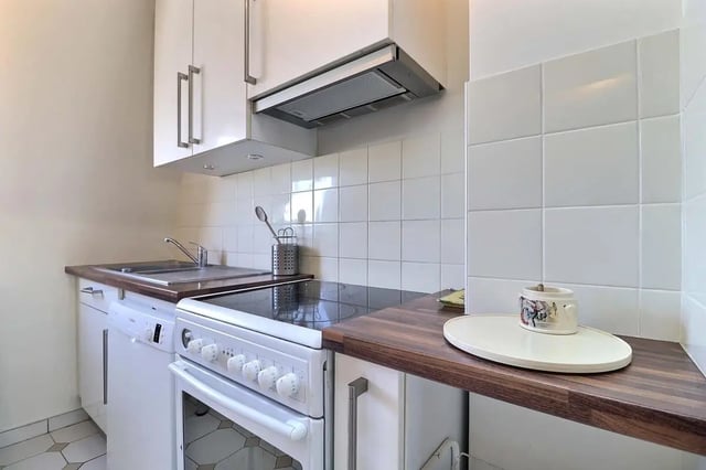 White cabinetry sink stove and dishwasher kitchen at Apartment in Rue César Franck, 75015 Paris, France in Paris Student Accommodation