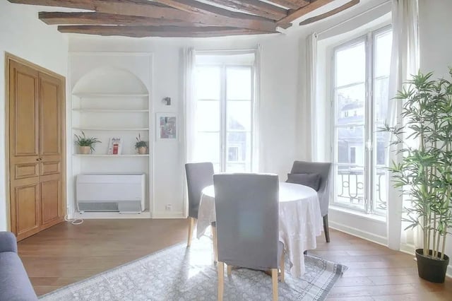 Dining table and chairs with plant living room at Apartment in Rue Dauphine, 75006 Paris, France in Paris Student Accommodation