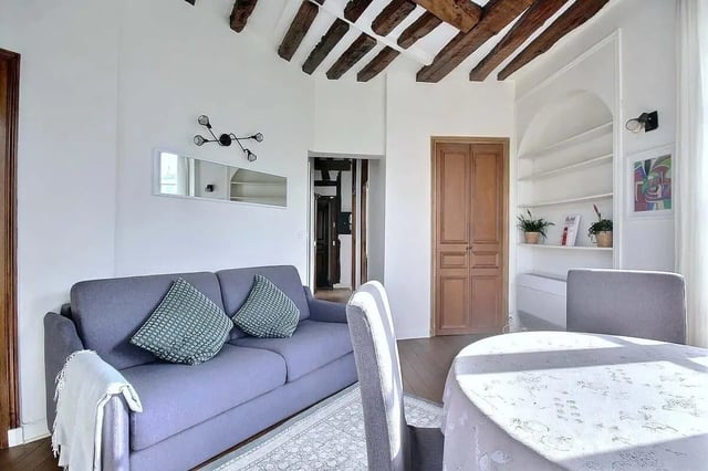 Sofa dining table and exposed beams living room at Apartment in Rue Dauphine, 75006 Paris, France in Paris Student Accommodation