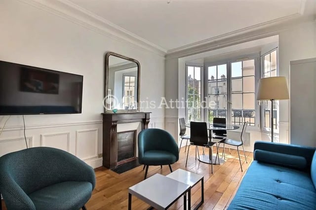 Sofa fireplace dining table chairs television living room at Apartment in Cité Voltaire, 75011 Paris, France in Paris Student Accommodation