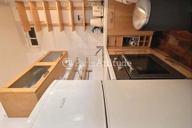 Cabinets stove sink refrigerator kitchen area at Apartment in Cité Voltaire, 75011 Paris, France in Paris Student Accommodation