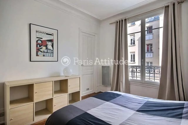 Bed with shelving unit and poster Bedroom at Apartment in Cité Voltaire, 75011 Paris, France in Paris Student Accommodation