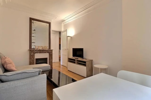 Sofa fireplace mirror TV unit living room at Apartment in Rue Etienne Jodelle, 75018 Paris, France in Paris Student Accommodation
