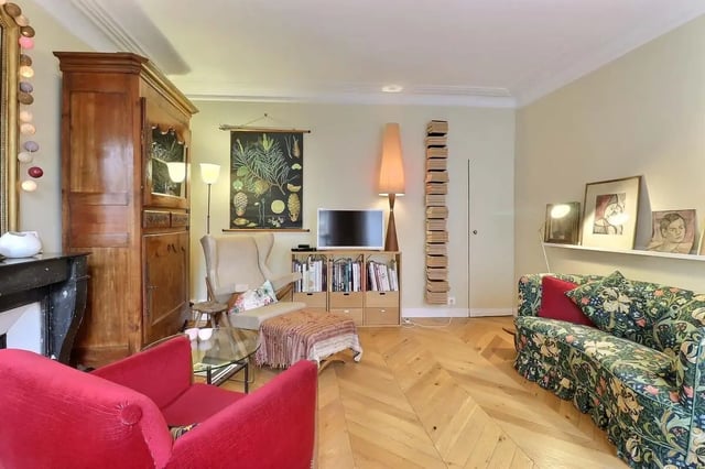Vintage armoire red chairs patterned sofa living room at Apartment in Rue Clauzel, 75009 Paris, France in Paris Student Accommodation
