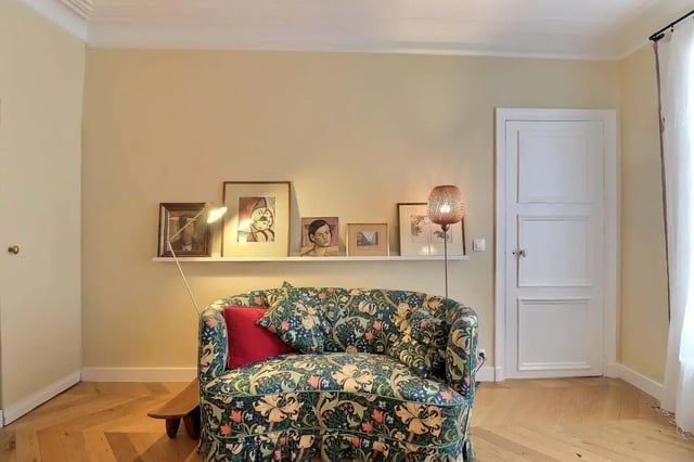 Floral sofa artwork shelf lamp living room at Apartment in Rue Clauzel, 75009 Paris, France in Paris Student Accommodation