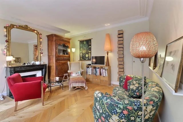 Red armchair antique cabinet patterned sofa living room at Apartment in Rue Clauzel, 75009 Paris, France in Paris Student Accommodation