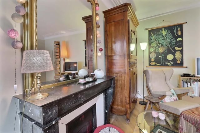 Fireplace mirror lamp wood cabinet chair living room at Apartment in Rue Clauzel, 75009 Paris, France in Paris Student Accommodation