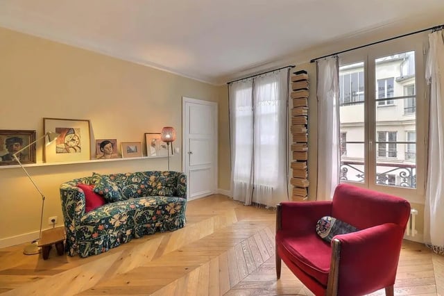 Floral sofa red armchair artwork living room at Apartment in Rue Clauzel, 75009 Paris, France in Paris Student Accommodation